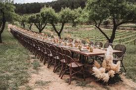 long wooden table and chairs for a wedding outside at vineyard wedding venue in Barcelona Spain Masia cabellut