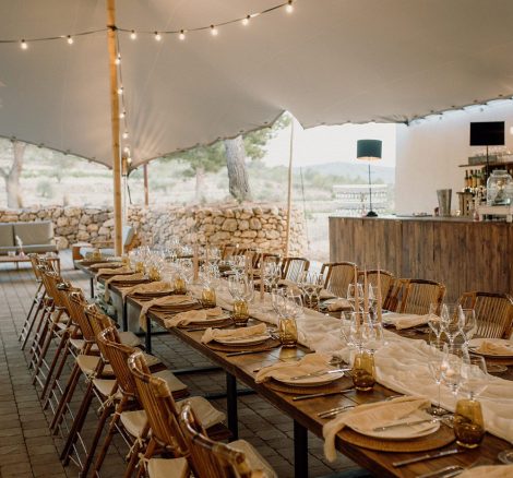 A long wooden wedding table under a marquee at Vineyard Wedding Venue Barcelona Masia Cabellut