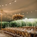 Two long wedding tables with floral arrangements hanging overhead at Vineyard Wedding Venue Barcelona Masia Cabellut