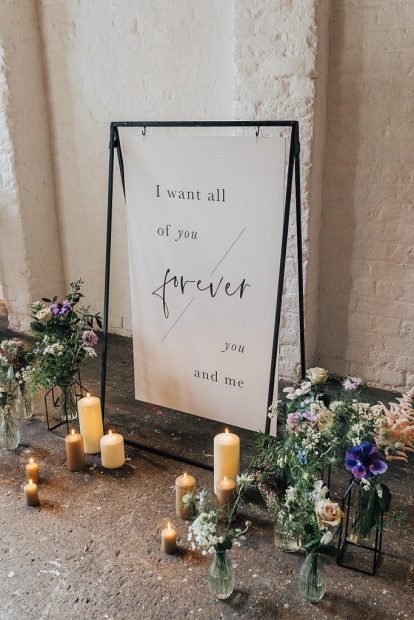 Wedding sign surrounded with floor candles and flowers unique blank canvas at blank canvas wedding venue in London, 100 Barrington