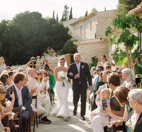 Image of bride walking down aisle with father at wedding venue Alcazar del Garraf