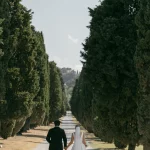 Couple walking down driveway entrance at wedding venue Relais Roncolo 1888, Italy