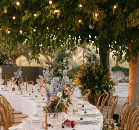 Table set up with fairy lights in trees at wedding venue Mas Palou