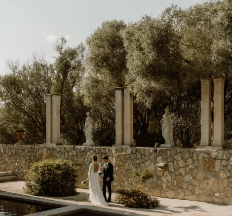 Married couple walking around the pool at wedding venue Finca Son Collell