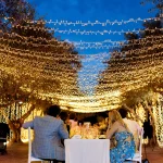 Image of lights hanging over seating at wedding venue Arbora Olea Luxury Resorts, Greece