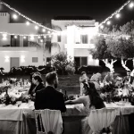 Image of couple sat at dining tables at wedding venue Arbora Olea Luxury Resorts, Greece