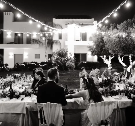 Image of couple sat at dining tables at wedding venue Arbora Olea Luxury Resorts, Greece