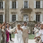 Married couple walking down aisle at wedding venue Chateau de Pont Bourguet