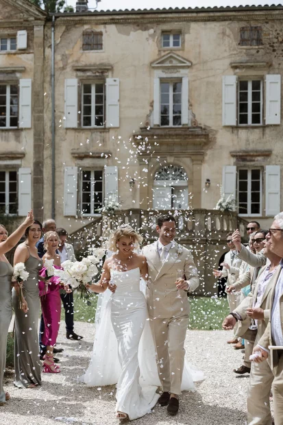 Married couple walking down aisle at wedding venue Chateau de Pont Bourguet