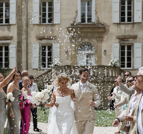 Married couple walking down aisle at wedding venue Chateau de Pont Bourguet