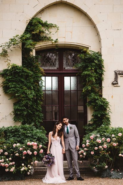 Couple stood in front of door at wedding venue Chateau Challain