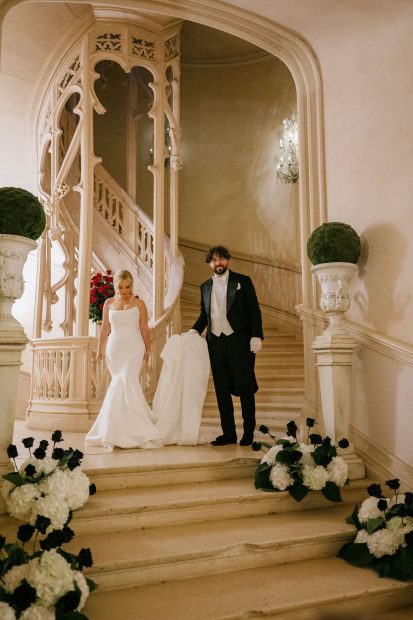 Image of couple walking down staurcase at wedding venue Chateau Challain