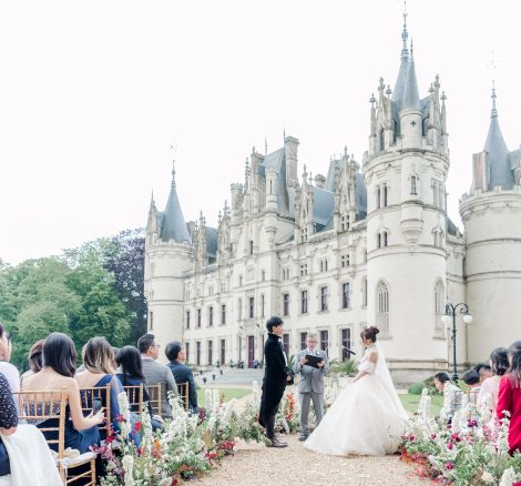 Image of couple at the end of aisle in front of wedding venue Chateau Challain