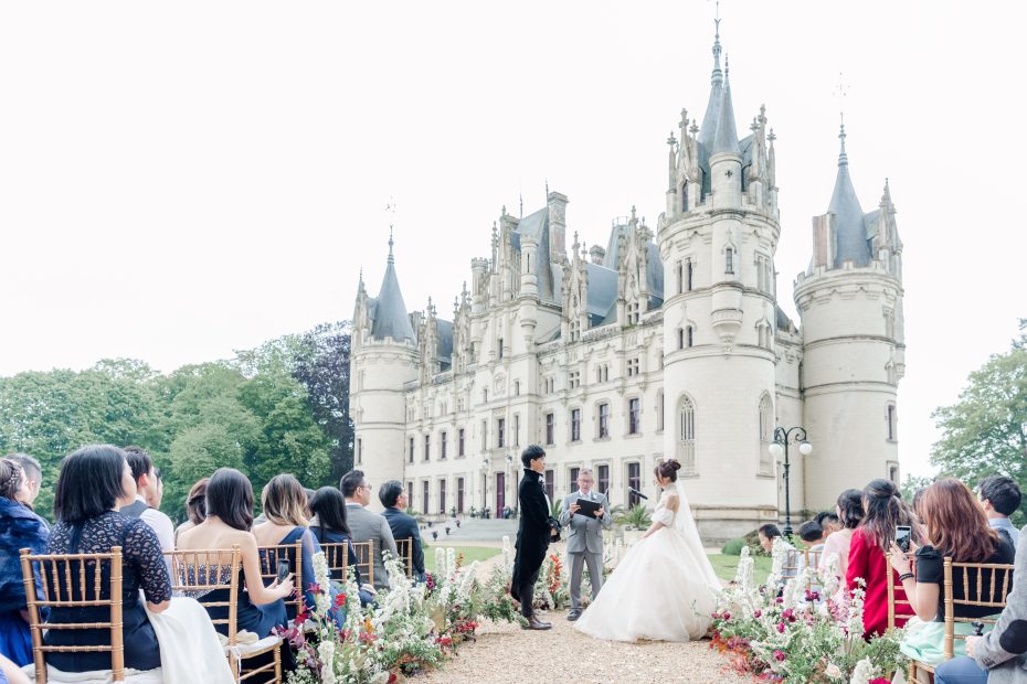 Image of couple at the end of aisle in front of wedding venue Chateau Challain