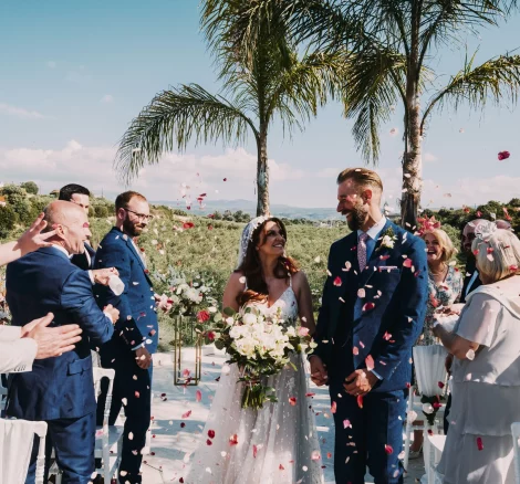 Image of couple walking down aisle which confetti at wedding venue Arbora Olea