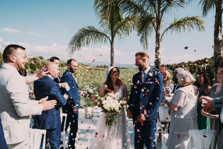 Image of couple walking down aisle which confetti at wedding venue Arbora Olea
