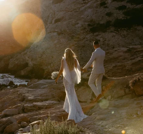 Image of married couple walking along the beach at wedding venue Elixir Ibiza