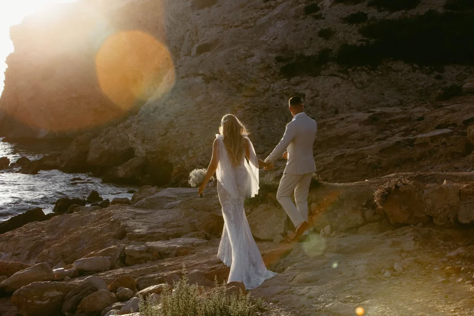 Image of married couple walking along the beach at wedding venue Elixir Ibiza
