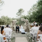 Image of couple sat at the end of aisle at wedding venue Domaine de Bonelli