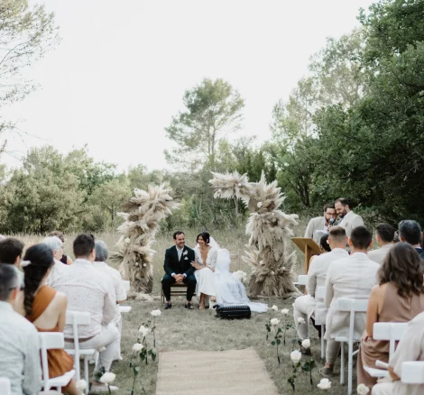 Image of couple sat at the end of aisle at wedding venue Domaine de Bonelli