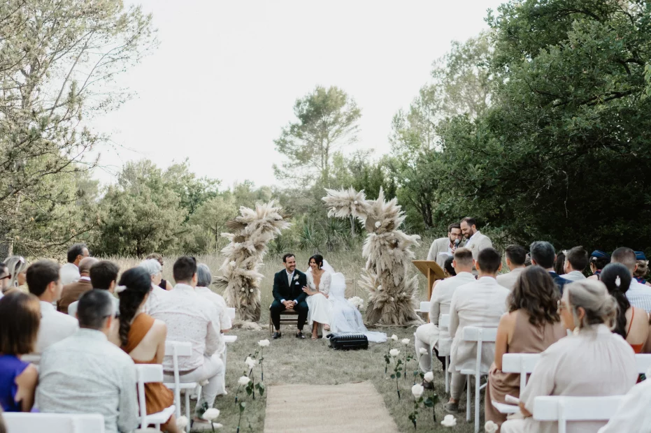 Image of couple sat at the end of aisle at wedding venue Domaine de Bonelli