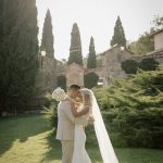 Just married couple on the lawn at San Pietro sopra le Acque wedding venue in Umbria, Italy