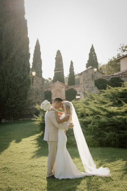 Just married couple on the lawn at San Pietro sopra le Acque wedding venue in Umbria, Italy