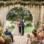 Image of married couple at the end of the aisle at wedding venue Chateau de Puissentut, France