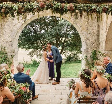 Image of married couple at the end of the aisle at wedding venue Chateau de Puissentut, France