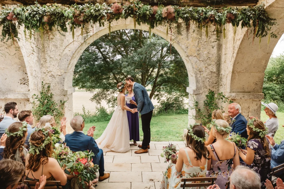 Image of married couple at the end of the aisle at wedding venue Chateau de Puissentut, France