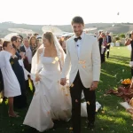 Couple walking down aisle with confetti at wedding venue Vitaleta, Italy