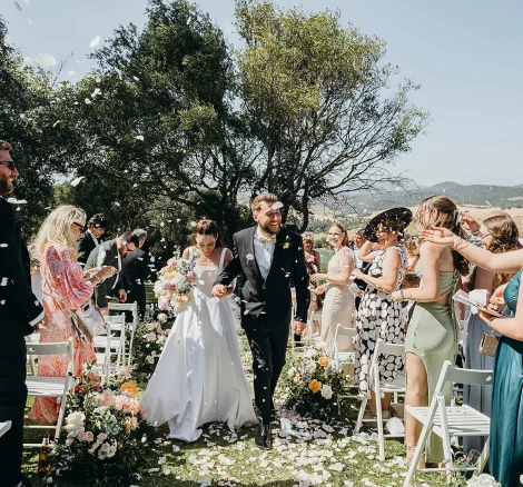 Image of married couple walking down aisle at wedding venue Hacienda Sambana