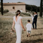 Image of couple walking through field towards estate, wedding vemue Terra Rosa