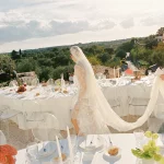 Bride walking between wedding tables at villa wedding venue in Puglia, Italy Villa Rocca 1914