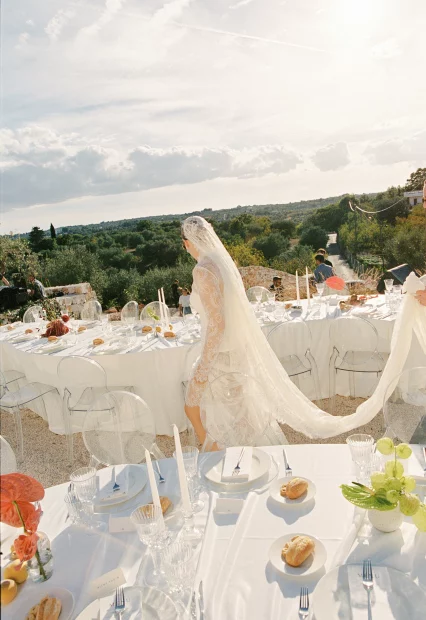 Bride walking between wedding tables at villa wedding venue in Puglia, Italy Villa Rocca 1914