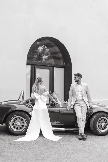 Image of married couple standing by car outside wedding venue El Serral Hotel, Spain